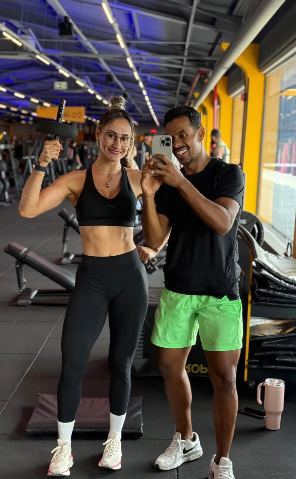 Daniel Ferreira com aluna em treino de musculação